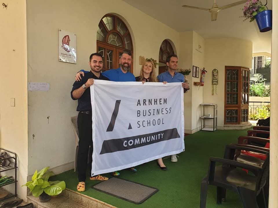 Visitors holding a community banner at the Astitva centre
