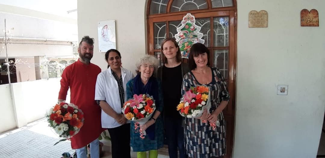 Visitors with flowers at the Astitva centre entrance